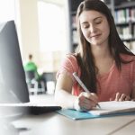 female-student-writing-notes-in-binder-in-college-library-175138304-58e638755f9b58ef7e7a2a5b