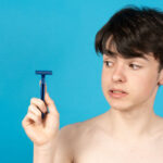teenager-boy-holding-razor